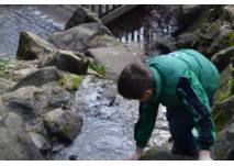 Kind am Bach auf dem Kinderspielplatz